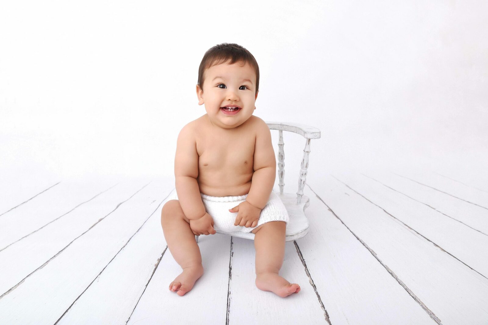 Bébé de 9 mois assis sur une petite chaise